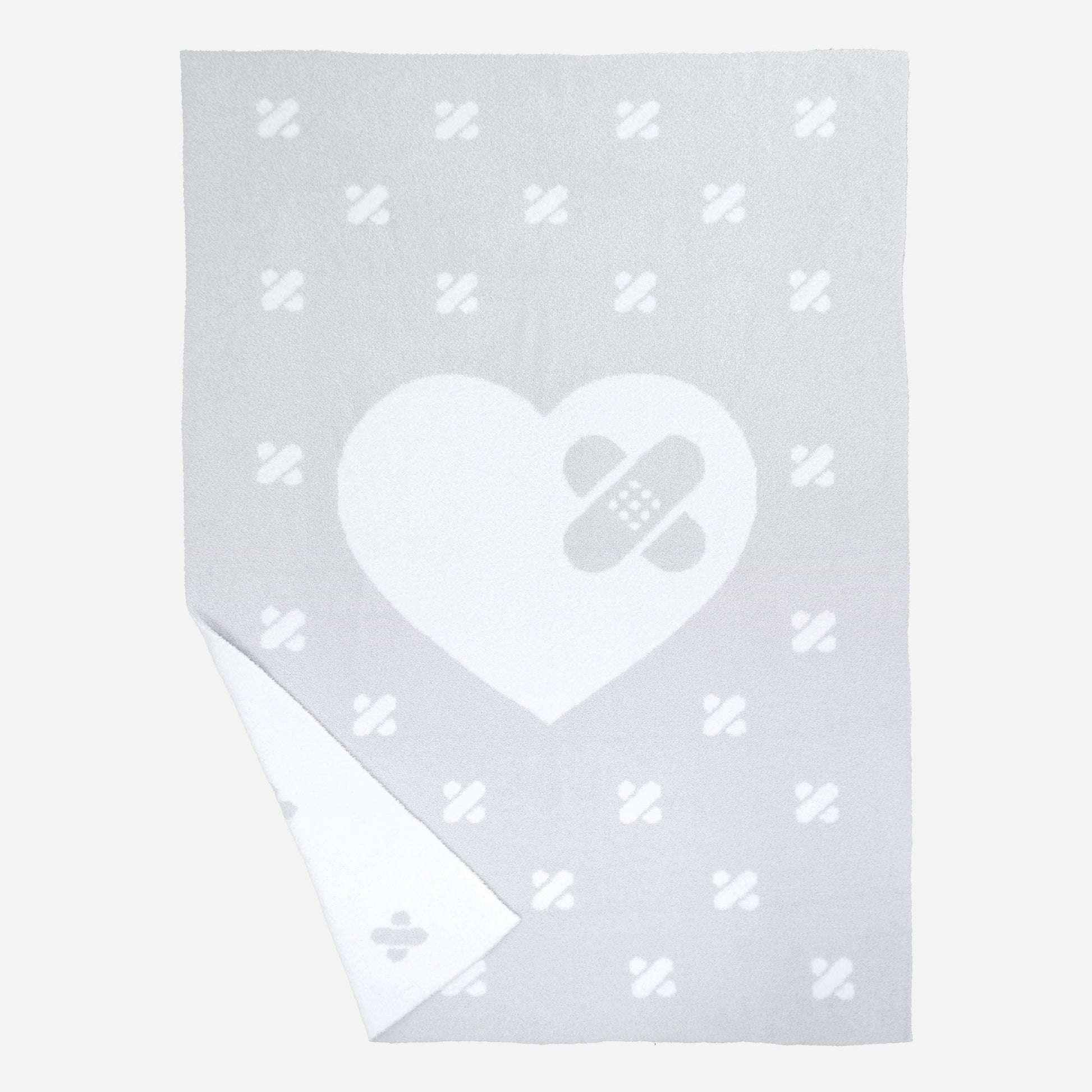 Griffin’s Heart Luxe Throw Blanket in Dove Gray/White with signature band-aid heart and reversible pattern. SKU: GH101 UPC: 198168891100